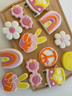 decorated cookies are arranged on a wooden tray