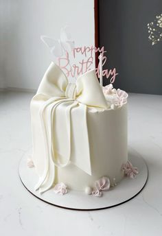 a birthday cake with white frosting and pink flowers