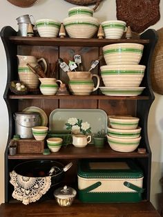 a wooden shelf filled with lots of dishes