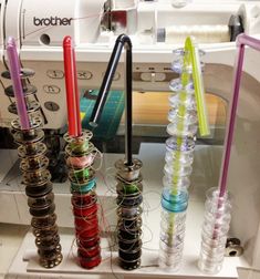 the sewing machine has many different colored threads on it's spools