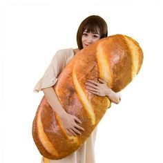 a woman holding a giant loaf of bread