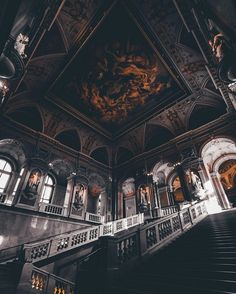 an ornately decorated building with stairs and chandeliers