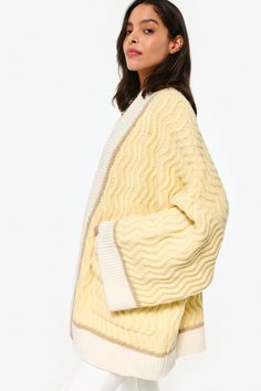 Crafted with 100% luxurious merino wool, the Oversized Cardi from King & Tuckfield is a must-have for your wardrobe. Designed by creative director Stacey Wood, this cardi embodies the brand's commitment to slow fashion and ethical production. With its oversized fit, it's the perfect statement piece for any outfit. Oversized Cream Cashmere Outerwear, Oversized Jacquard Knit Cardigan, Oversized Textured Knit Cream Outerwear, Spring Beige Merino Wool Outerwear, Oversized Wool Sweater Coat For Spring, Oversized Cream Merino Wool Sweater, Oversized Merino Wool Sweater For Spring, Winter Wool Sweater For Daywear, Spring Merino Wool Cable Knit Sweater