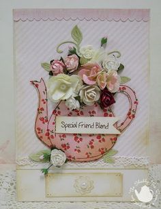 a card with flowers in a tea pot