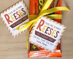 some candy bar wrappers are tied up with a yellow ribbon on the top and bottom