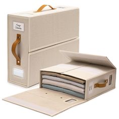 an open file box with papers in it next to a closed file case on a white background