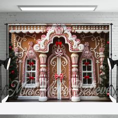 a gingerbread house is decorated with candy canes and bows for the holiday season