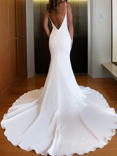 a woman in a white wedding dress looking back