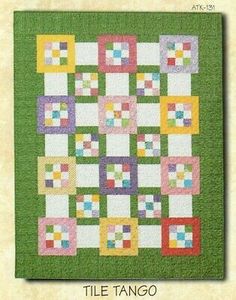 a green and yellow quilt with squares on it