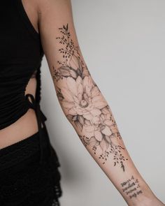 a woman's arm with flowers on it and words written in cursive writing