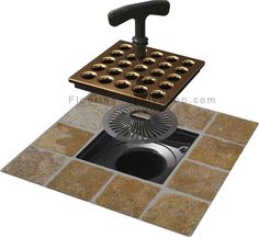 a drain in the ground with a grate on it's side and an object above it that appears to be made out of metal