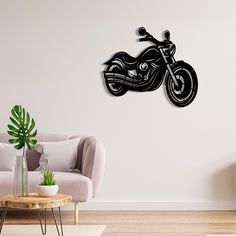 a living room with a couch and a motorcycle wall clock on the wall above it