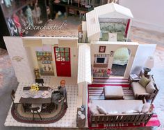 a doll house with furniture and accessories in the living room, dining area and bedroom