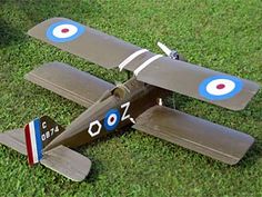 an old model airplane laying on the grass