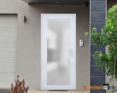 a white door is open in front of a gray house with a potted plant next to it