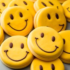 many yellow cookies with smiley faces on them