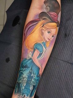 a woman with a hat and dress on her arm is shown in this disney tattoo