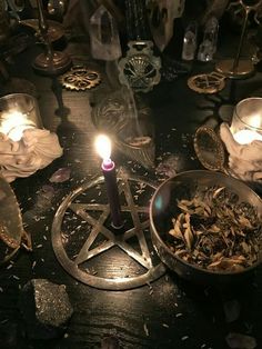 a table topped with candles and dishes filled with food