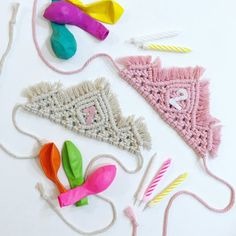 various craft items are laid out on a white surface with sparkles and beads around them