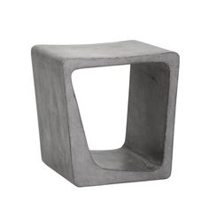 a concrete cube shaped table with one section cut out