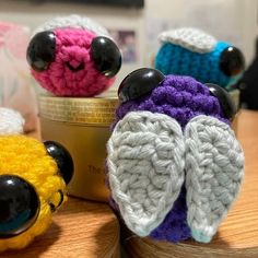 three small crocheted animals sitting next to each other on top of a table