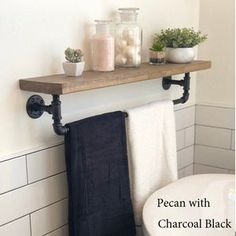 a bathroom shelf with towels and plants on it