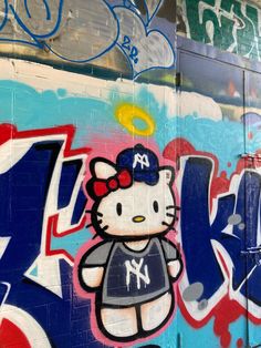 graffiti on the side of a building with hello kitty painted on it's face