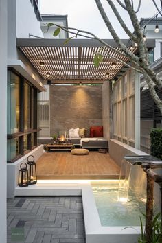 an outdoor living area with a couch and water feature