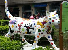 there is a statue of a cat that has spots all over it's body