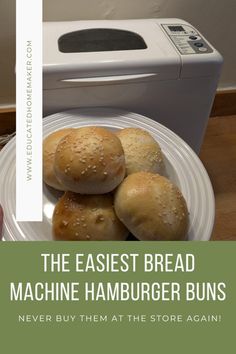 the easyest bread machine hamburger buns are on a plate next to a toaster