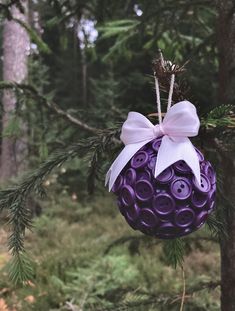 a purple ornament hanging from a tree