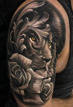 a man's arm with a lion and roses tattoo on the side of his body