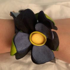 a close up of a person's arm with a flower bracelet on it,