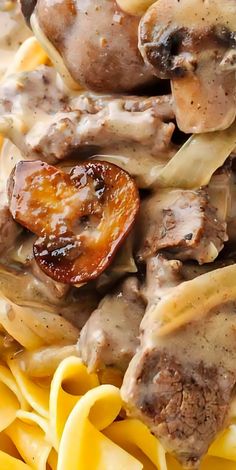 pasta with meat, mushrooms and sauce on it