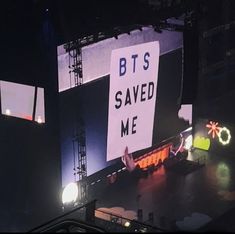 an overhead view of a stage with lights and signs reading bt's saved me