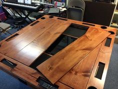 a table made out of wood with an electronic keyboard in the background