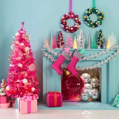 a pink christmas tree sitting next to a fireplace