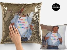 a person holding onto a sequinized pillow with an image of a man on it