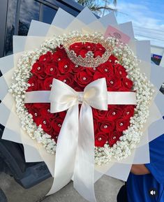 a heart shaped wreath with roses and a tiara