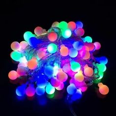 a bunch of multi colored lights on a black background