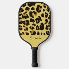 a yellow and black leopard print paddle with the name luvinda written on it