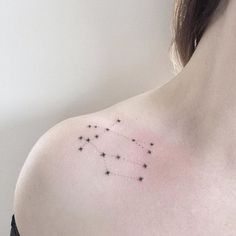 a woman's chest with small stars on it