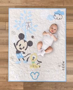 MickeyMilestone Quilt is perfect gift to welcome a new baby and celebrate each month of baby's first year. It is perfect to photograph and commemorate those milestones. This quilt is made with a Mickey themed cotton panel, backed in blue polka dot cotton fabric with cotton batting. This also includes the Mickey shaped wooden month marker. Made from wood and cut using a laser machine, this marker is the perfect finishing touch for counting months as the baby grows month by month. Place the baby on the quilt and the marker on the correct month, photograph and share with friends and family! - Quilt measures 44 inches by 36 inches - Quilt is three quilted layers, cotton batting between a top layer Mickey panel and backed in blue polka dot cotton - Month marker is shaped like a Mickey head and Milestone Quilt, Mickey Nursery, Nursery Theme, Mickey Head, Baby Mouse, Baby Milestone, Babies First Year, Laser Machine, Mickey Ears