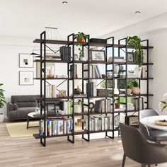 a living room filled with furniture and bookshelves next to a dining room table