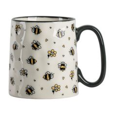 a black and white coffee mug with bees on it