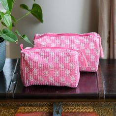 Available in 2 sizes, these quilted wash bags offer a stylish alternative to carrying your toiletries on holiday, or for storing your make-up at home. Finished with a waterproof lining, worrying about spills is a thing of the past. They make great gifts through out the year. Details: - Quilted toiletry bag with padded cotton - Hand block printed using eco friendly dyes - Two internal pockets - Zipper with tassel - Waterproof lined  Dimensions - Big: 30L x 10H x 13W cm Small: 20L x 8H x 10W cm Please note, this is a handmade item, and each piece is unique. There might be slight colour and print variations, which is a part of the beauty of these handmade products. Everyday Quilted Rectangular Pouch, Rectangular Quilted Pouch, Pink Quilted Pouch Bag, Eco-friendly Rectangular Cosmetic Bag For Daily Use, Pink Quilted Bag For Gift, Quilted Pouch Bag For Gift, Quilted Pouch Bag As Gift, Quilted Rectangular Bag For Gift, Quilted Rectangular Bag For Gifts