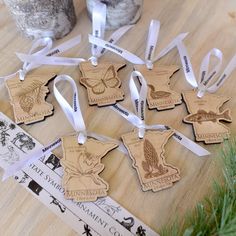 several wooden ornaments with white ribbons on a table