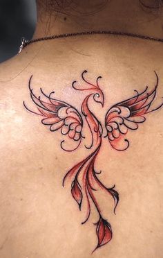 the back of a woman's neck with a tattoo design on it