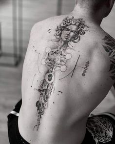 a man with a tattoo on his back