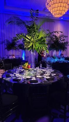 a table set up with plates and place settings for formal dinnereons in a banquet hall